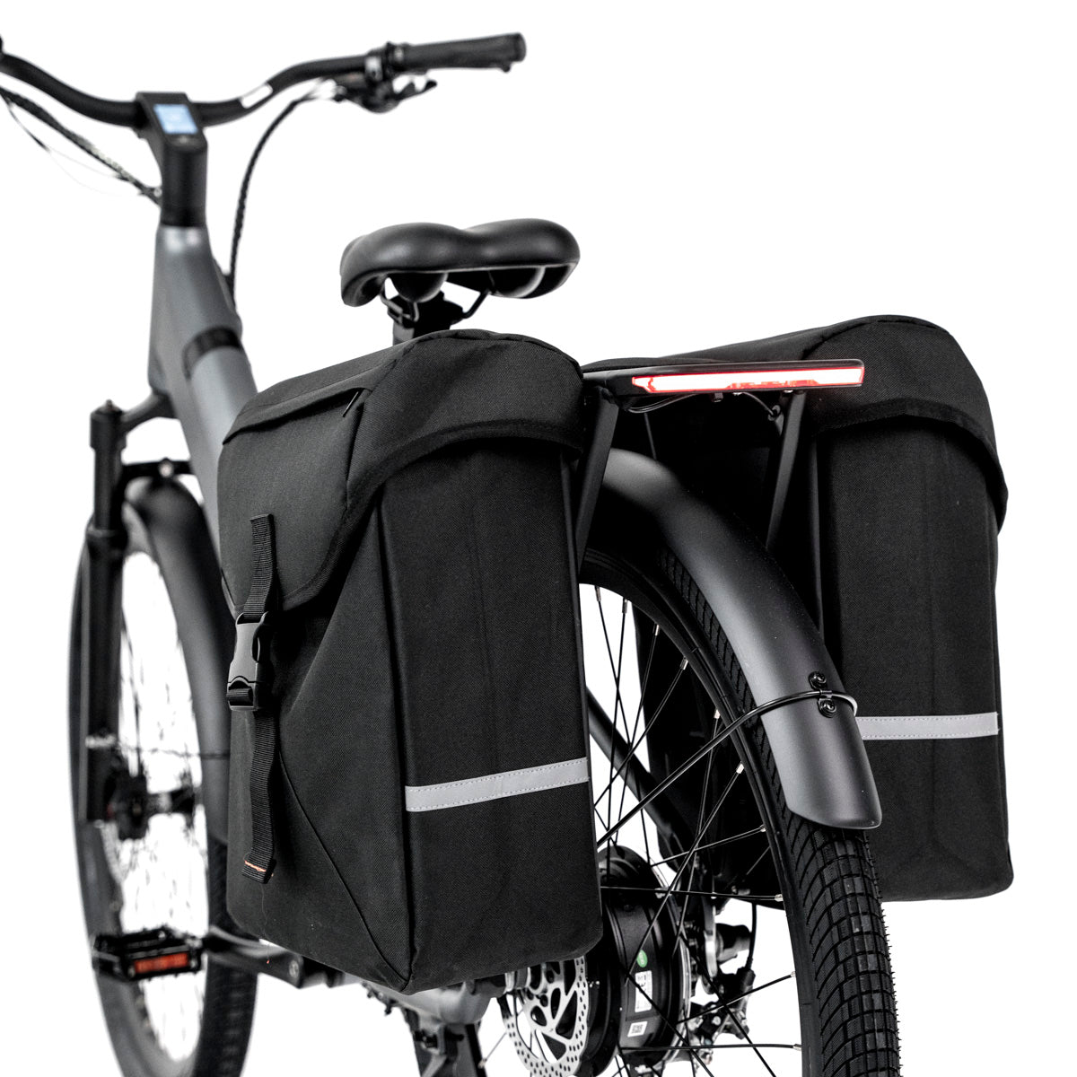 Close-up view of the dual black pannier bags and the rear light on the FavoriteBikes Hybrid CSC Ebike, showing the spacious storage options